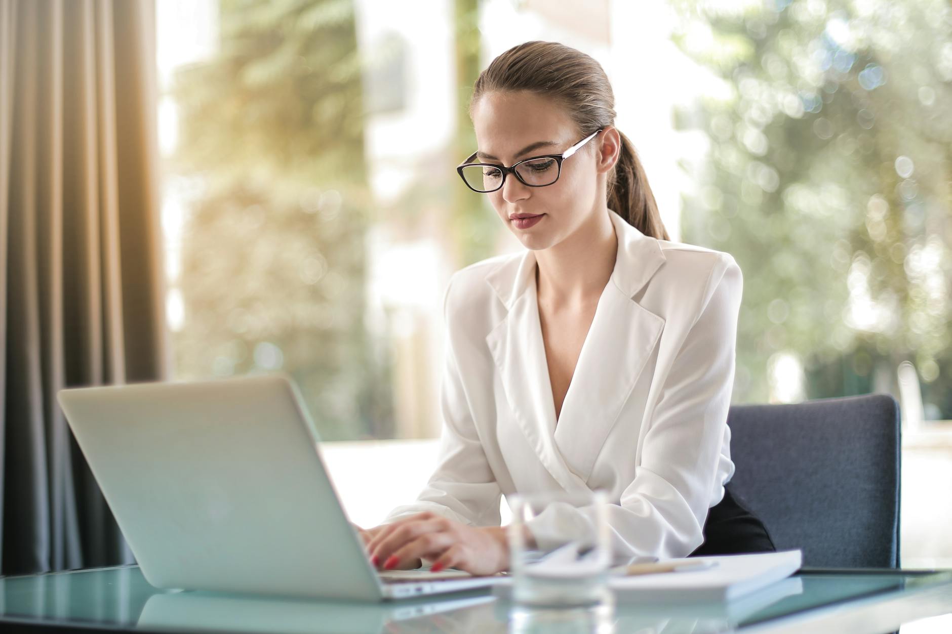 Konzentrierte Unternehmerin, Die Auf Laptop Am Arbeitsplatz Tippt